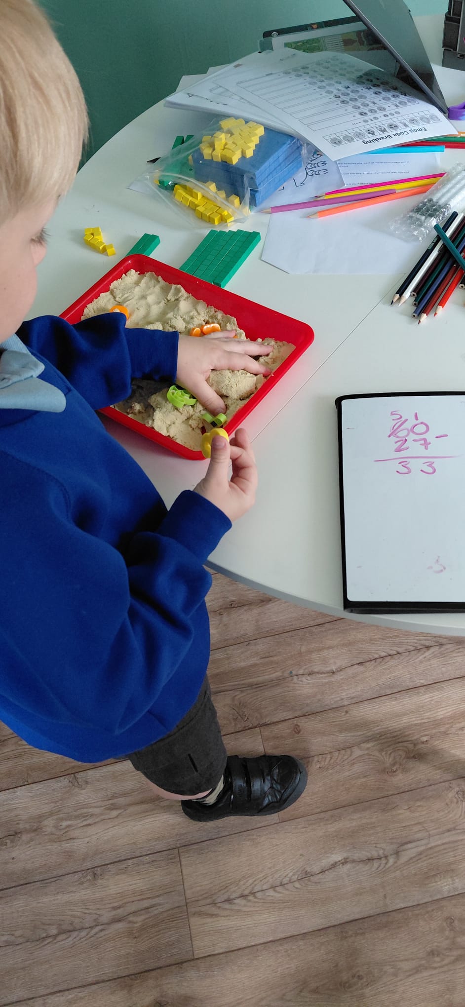 Hands-on maths tuition with sensory tray and resources
